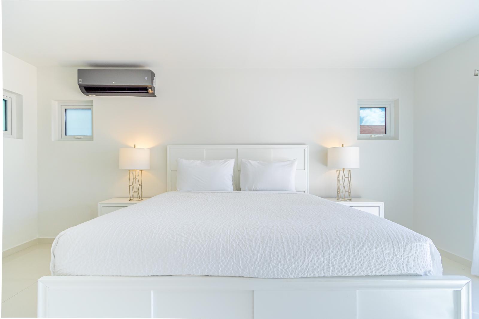 Resplendent Bedroom of the 3BR house in Noord Aruba - Modern bedroom with sleek design and natural light - King Size Comfy Bed - Cozy retreat with a plush bed, perfect for relaxation