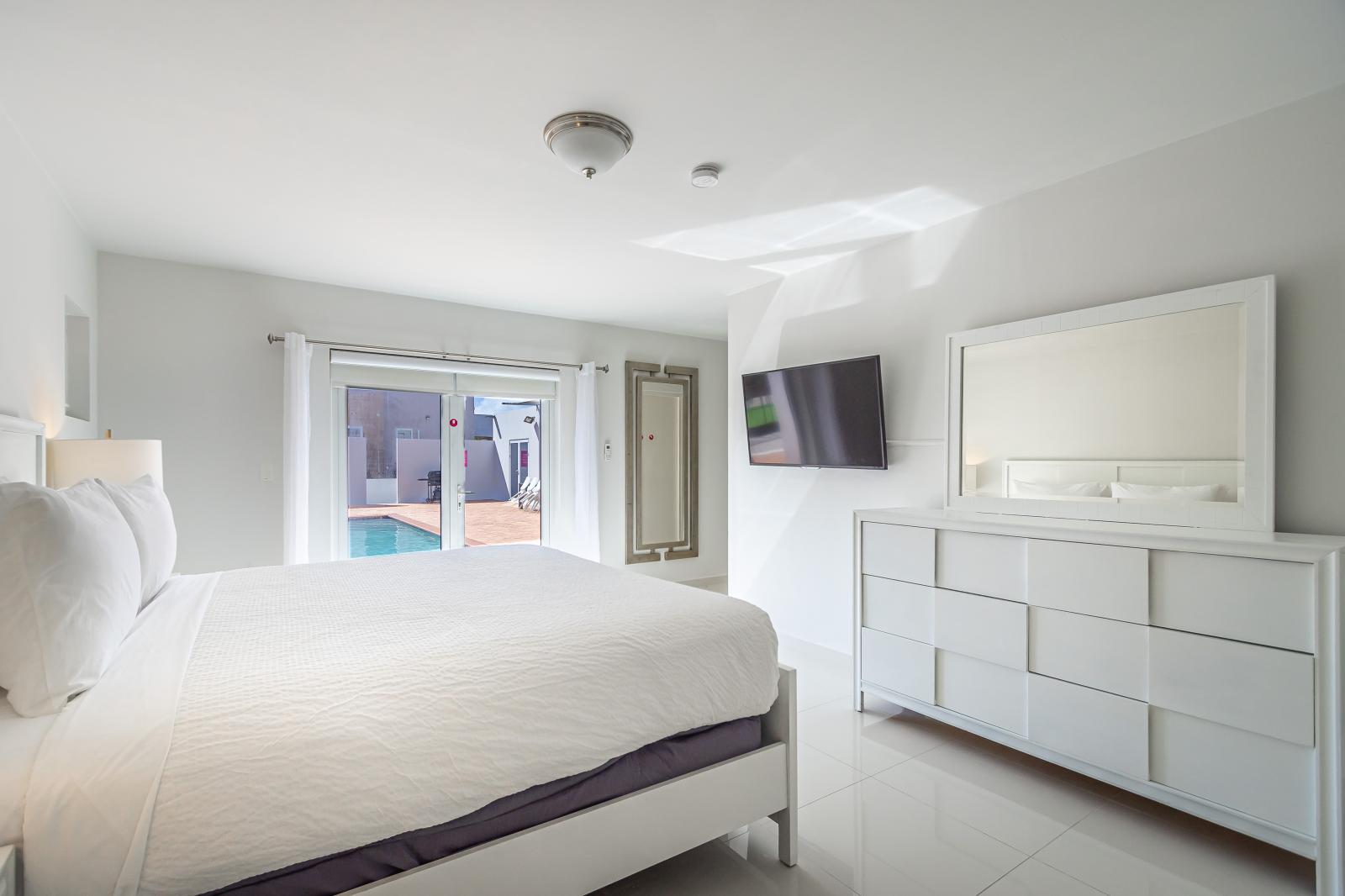 Secluded Serenity: Retreat to Bedroom 1, Offering Private Access to the Backyard, Where Tranquility Meets Convenience for Your Ultimate Relaxation