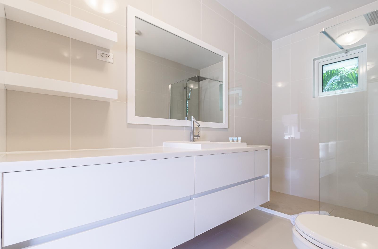 Indulge in Luxury: Bathroom 1 Features a Spacious Vanity, a Toilet, and a Luxurious Walk-in Shower, Providing the Perfect Blend of Comfort and Convenience