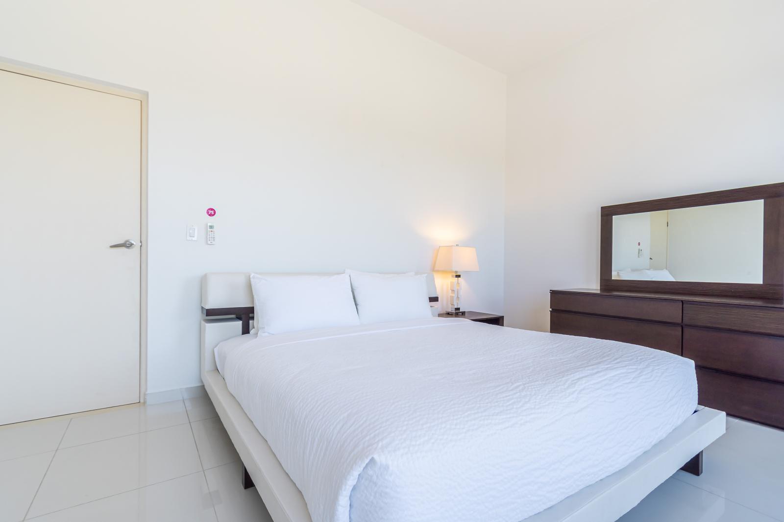 Bedroom 2 has a classic dark-wood dresser, and an ultra-convenient slatted armoire.