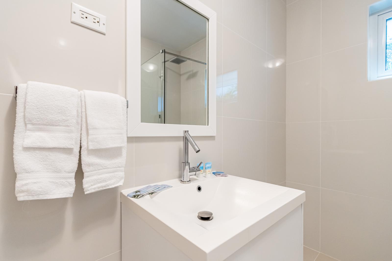 Sleek Sophistication: Bathroom 2 Boasts Modern Finishes Throughout, Elevating Your Experience with Contemporary Style and Elegance