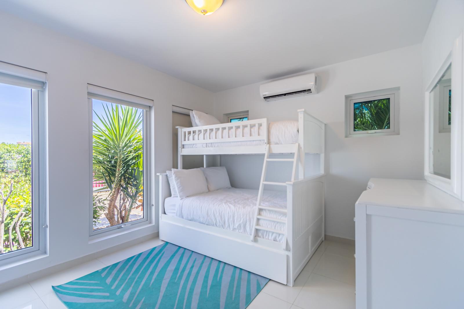Family-Friendly Comfort: Bedroom 3 is Furnished with a Bunk Bed Featuring a Full and Single Bed, Providing Ample Sleeping Space for Children or Guests