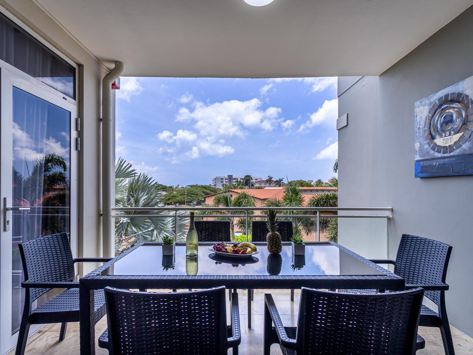 Scenic balcony of the 2BR Condo in Oranjestad Aruba - Patio with outside dining table - Cozy outdoor retreat with seating - 6 Persons Dining - Refreshing Atmosphere