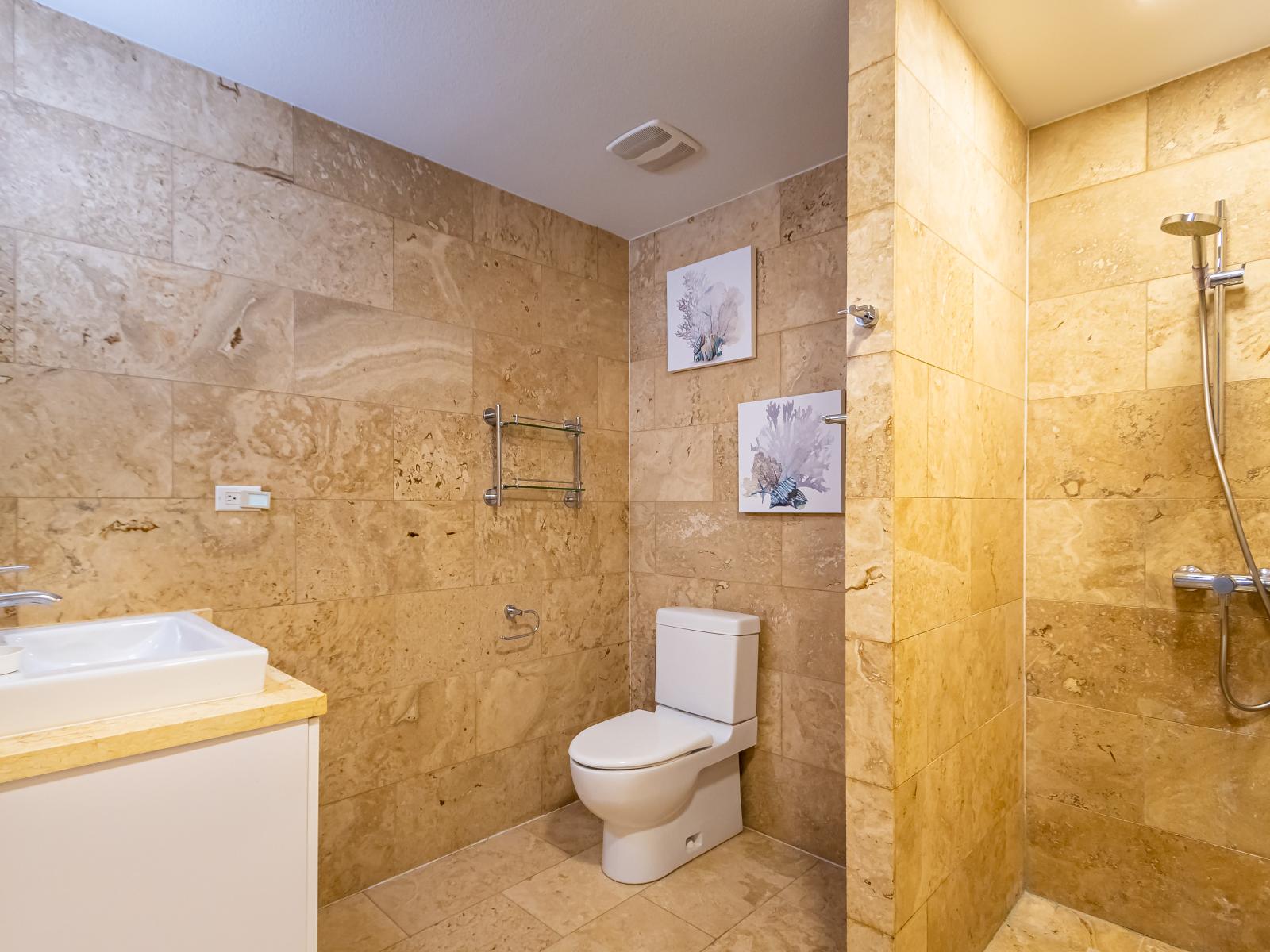 Imposing Bathroom of the 2BR Condo in Oranjestad Aruba - Chic design featuring a sleek vanity and upscale lighting - Walk-in Shower - Meticulous design, from elegant tiles to faucets