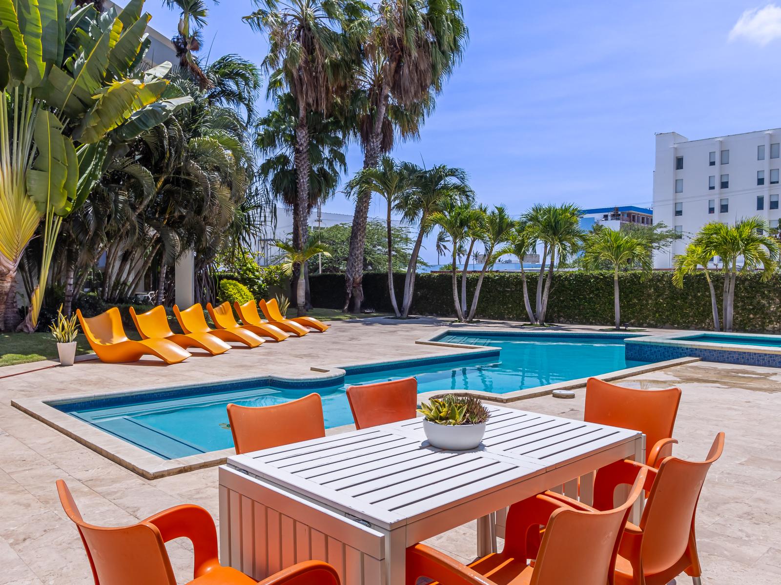 Table outside for meals by the pool - Can accommodate 6 guests - Alfresco elegance awaits under the open sky - Outstanding Pool views - Tropical trees and plants