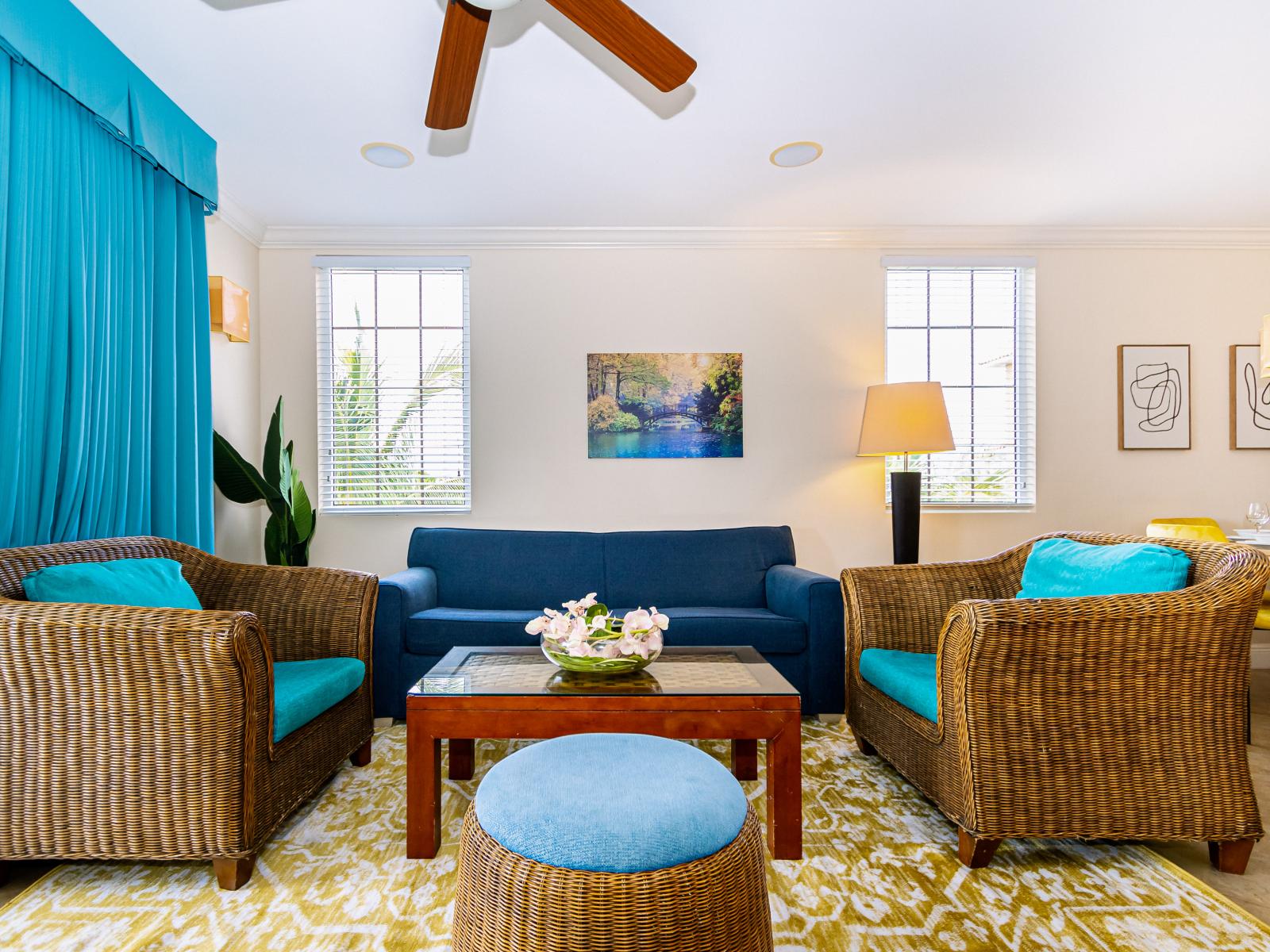 Sink into comfort in our inviting living room, adorned with a delightful mix of vibrant blues that create a relaxing ambiance, perfect for gatherings and cherished moments with family and friends.