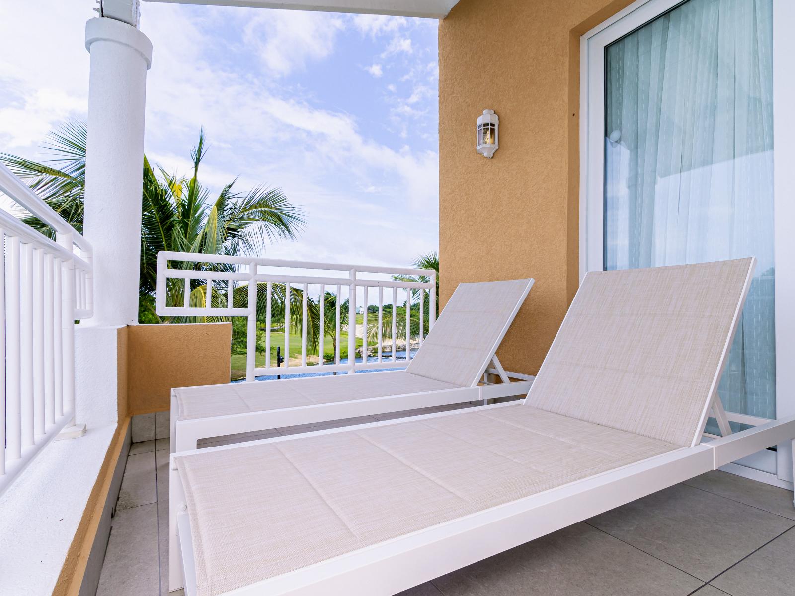 Spacious balcony with lounge chairs and great views