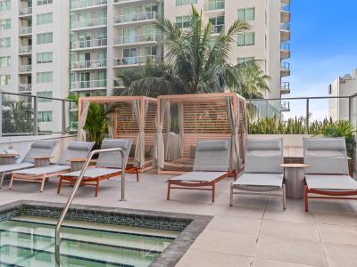 Pool deck with hot tub and sun beds