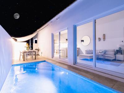 Opulent Pool Area of the Home in Oranjestad Aruba - Night Time Backyard with pool lights - Beautifully Designed space - Outdoor Dining Option