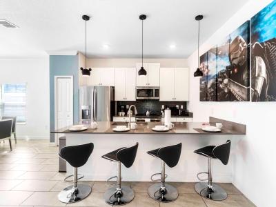 Sleek and Stylish: Elevate Your Dining Experience with our Kitchen Counter-Top Table, Accompanied by Chic High Chairs.