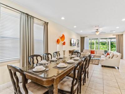 Welcoming Dining Area of the Home in Kissimmee Florida - Indulge in Culinary Delights Together - 8 Persons Dining - Chic dining area featuring a stylish table and contemporary seating