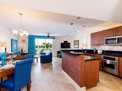 Lavish living and dinning area of the condo in Noord Aruba - Cozy sofas - Elite 4 persons dining - Beautifully located large glass doors that leads to private balcony with mesmerizing views - Elite ambiance - Availability of TV and Netflix