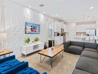 Lush living area of the home in Kissimmee Florida - Grand living room with an open layout, creating a sense of spaciousness - Stylish furniture arrangement providing comfort and a cohesive look