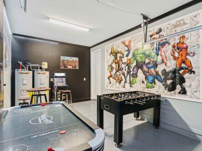 Fun game room of the home in Kissimmee Florida - Game room with air hockey table, foosball  and arcade - Unleash your competitive spirit in our game room - Classic arcade games that evoke nostalgia and excitement