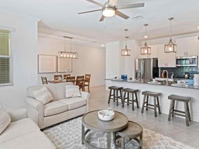 Open plan townhouse in Kissimmee Florida - Seamlessly connection between dining area, kitchen and the living area - Plush and comfortable seating arrangements - Stylish, contemporary furnishings enhancing the aesthetic