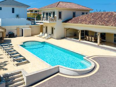 Enjoy the lap pool of this Villa with multiple chairs for guests to lie on and with a gazebo for a nice shade on a sunny day