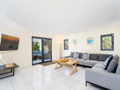 Ostentatious Living Area of the Villa in Noord Aruba - Smart TV and Netflix - Elegant Decor, adding sophistication - Comfy and Cozy Sofas - Spacious living room with glass sliding door access to the backyard