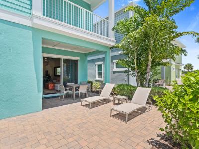 Refreshing outdoor area of the townhouse in Reunion Florida - Lounge chairs for relaxation - Relax and unwind in serene setting - Find tranquility surrounded by greenery and nature