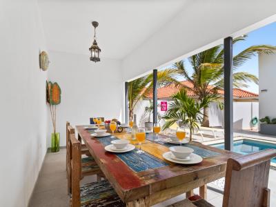 Savor your meals in our stunning outdoor dining area overlooking the pristine pool. Enjoy the perfect blend of alfresco dining and serene water views, making every meal a memorable experience.