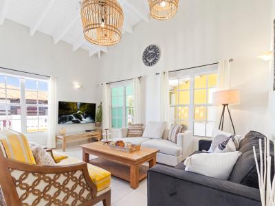 Lavish Living area of the 3BR House in Noord, Aruba - Cosy sofas - Wonderful surrounded by large windows for light, air and beautiful views - Fabulous sitting with panoramic decor - Availability of TV and Netflix - Majestic chandeliers