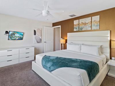 Bedroom 2 with a king size bed and a private bathroom offers a comfortable and convenient space.  The bed is  adorned with comfortable bedding, pillows to enhance its visual appeal and comfort.