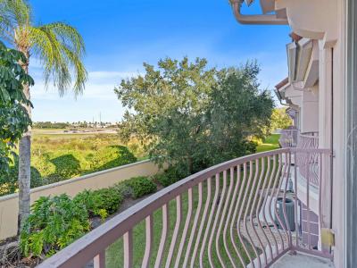 Comfortable living room of the Townhouse at Vista Cay Resort in in Orlando - Welcoming environment with Cozy sofas for relaxation. - Blending modern comfort and decored with aesthetics wall paintings. - Living area with glorious private balcony