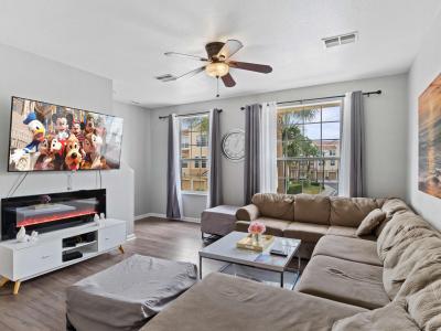 Lush living area of the townhouse in Orlando Florida - Grand living room with an open layout, creating a sense of spaciousness - Stylish furniture arrangement providing comfort and a cohesive look