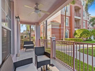 Step out onto the balcony overlooking Vista Cay Clubhouse and the main pool, offering convenient access to resort amenities and stunning views.