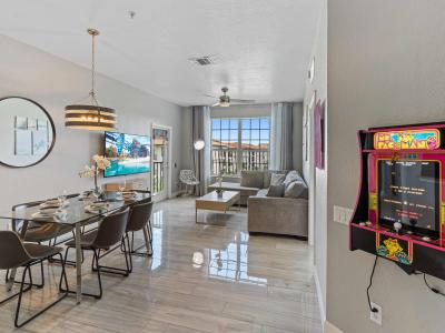 Living room with arcade game of the condo in Orlando Florida - Living room is family-friendly, providing a fun and engaging space for all ages to enjoy together - Smart TV and variety of arcade games available, including classics