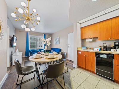 Inviting dining area and kitchen of the condo in Orlando Florida - Open-concept space seamlessly connected to a stylish dining space and kitchen - Featuring a stylish table and contemporary seating - Near kitchen for ease and convenience