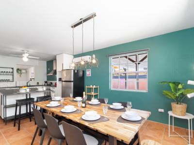 Lofty Dining Area of the 3BR House in Noord Aruba - 6 Persons Dining - Artfully arranged table settings for a touch of elegance - Open layout seamlessly connecting the dining area to the kitchen