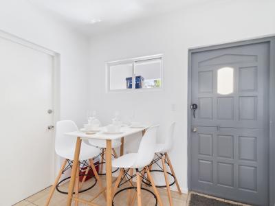 Eclat Dining Area of the 2BR condo in Noord Aruba - 4 Persons Dining - Quality materials, such as a sleek dining table and comfortable chairs - Open layout seamlessly connecting the dining area to the kitchen