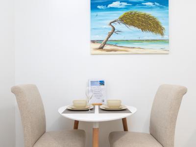 Immerse yourself in the charm of Aruban culture at our dining table adorned with lovely local art, adding a touch of island elegance to every mealtime.