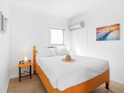 Exquisite Bedroom of the Apartment in Noord Aruba - Comfortable bed, perfect for relaxation - Bedroom with a cozy ambiance, blending comfort and aesthetics - Air conditioning