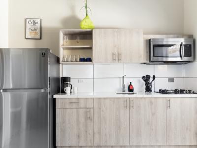 Well-Designed Kitchen of the Apartment in Noord Aruba - Integrated appliances for a seamless and stylish appearance - Thoughtful placement of kitchen essentials for easy access - Coordinated kitchen decor for a polished and inviting atmosphere