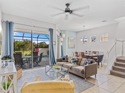 Lavish Living Area of the Townhouse in Davenport Florida - Beautiful living room with an open layout, creating a sense of spaciousness - Smart TV and Netflix - Open-concept living area seamlessly connected to a stylish dining space