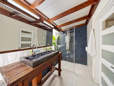 Modern bathroom with a walk in shower connected to bedroom 1