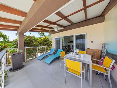 Cozy lounge chairs and outdoor dining table on the private patio