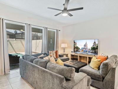 Plush Living Area of the Townhouse in Kissimmee Florida - Comfy Sofas - Easy access to outdoor with seating and Pool - Smart TV and Netflix - Elegantly decorated space with a neutral color palette for a timeless appeal