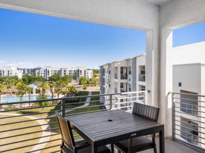 Imposing Private Balcony of the Condo in Kissimmee - Mesmerizing Pool and surrounding views from the balcony - Beautiful 2 Persons Dinning for having coffee in the refreshing atmosphere - Fabulous sitting space