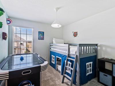 Experience the ultimate kid's haven in our Marvels themed bedroom of the home in Kissimmee - Featuring a bunk bed for cozy sleepovers and an air hockey table for exhilarating entertainment. - Fostering a space for imaginative play and restful sleep