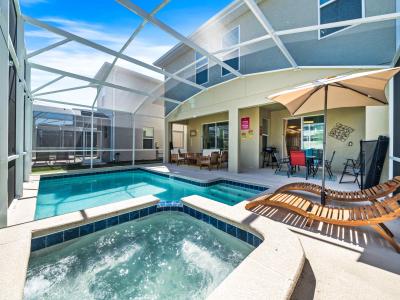 Refreshing Private Pool area of the home in Davenport - Stunning poolside siting and dinning area under the shade -  Cozy beach chairs available with an umbrella shade - Refreshing hot tub along with the pool