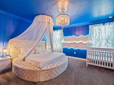 Majestic Bedroom of the home with private bathroom in Davenport - Luxury Double bed with neat and clean linen and baby crib - Carpeted floor - Stunningly painted walls - Luxurious Chandelier and table lamps