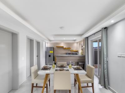 Sleek dining area of the apartment in Oranjestad Aruba - Featuring a stylish table and contemporary seating - 4 Persons dining - Open-concept design facilitates seamless flow between living, dining, and kitchen