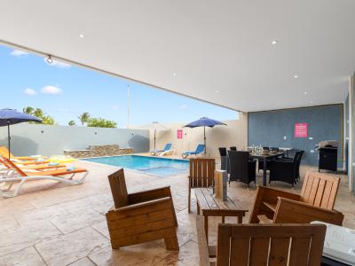 Refreshing shared pool area of the apartment in Oranjestad Aruba - Great for families with kids - Enjoy leisurely moments in inviting pool area - Cozy outdoor retreat with seating