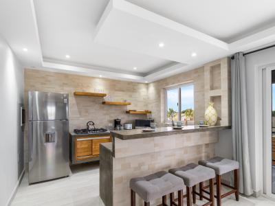 Beautiful kitchen of the apartment in Oranjestad Aruba - Modern kitchen with stainless steel appliances - Breakfast bar and high chairs - Thoughtful placement of kitchen essentials for easy access