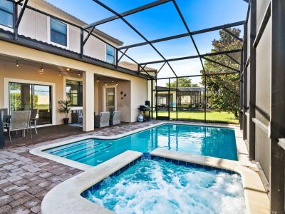 Enclosed private pool and spa area featuring a crystal-clear swimming pool and a relaxing hot tub - Comfortable poolside loungers for sunbathing and relaxation - Private and serene setting with a lush green backdrop, perfect for relaxation