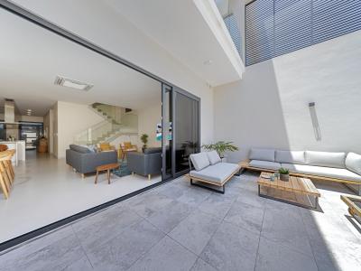 Easy backyard access from the living area through glass sliding doors creating an open atmosphere  - Seamless integration of indoor and outdoor living areas creates a truly exceptional experience - Enjoy cozy nights indoor or lively outdoor dining