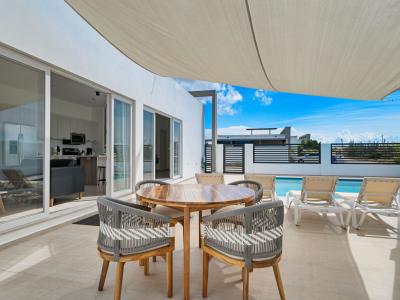 - Enjoy outdoor dining by the pool on this elegant patio, perfect for meals or lounging in the sun - Relax on comfortable lounge chairs with pool access for a refreshing dip anytime - Indoor and outdoor spaces seamlessly blend for open, modern living