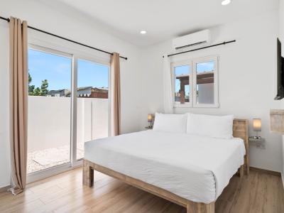 - Relax in this serene bedroom with a plush king-size bed, perfect for restful nights - Step out onto your private balcony and enjoy fresh breezes and sunshine - Contemporary décor and tranquil ambiance set the stage for ultimate relaxation